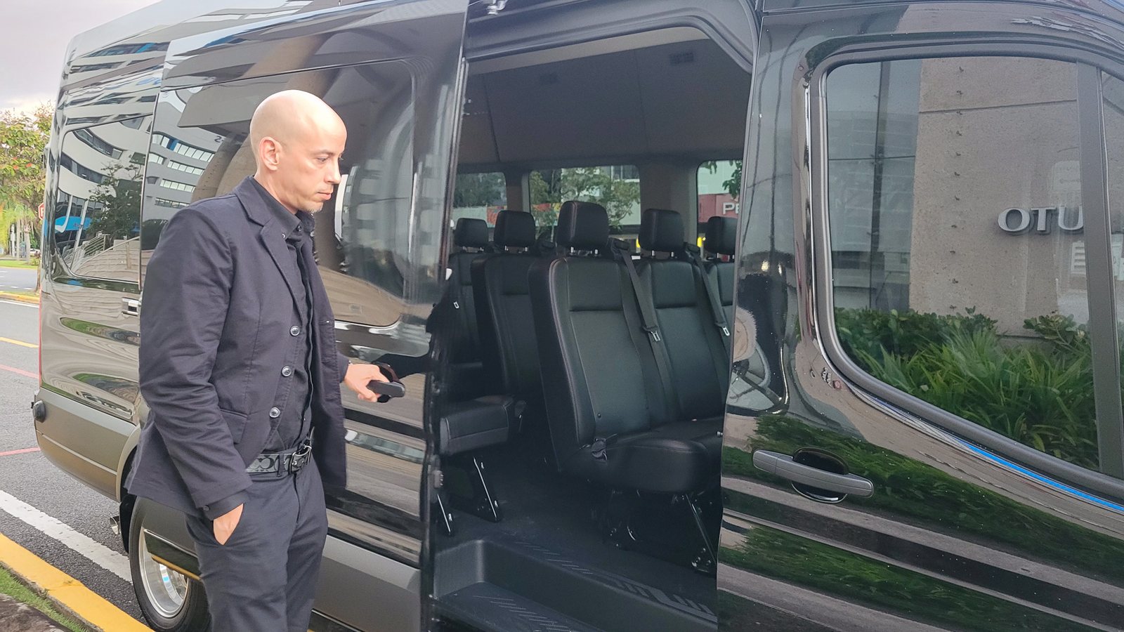 Driver opening the door of the private tour van with leather seats in Puerto Rico